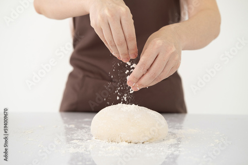 Cooking dough by woman hands for homemade pastry bread, pizza, pasta recipe preparation on white table background.copy space