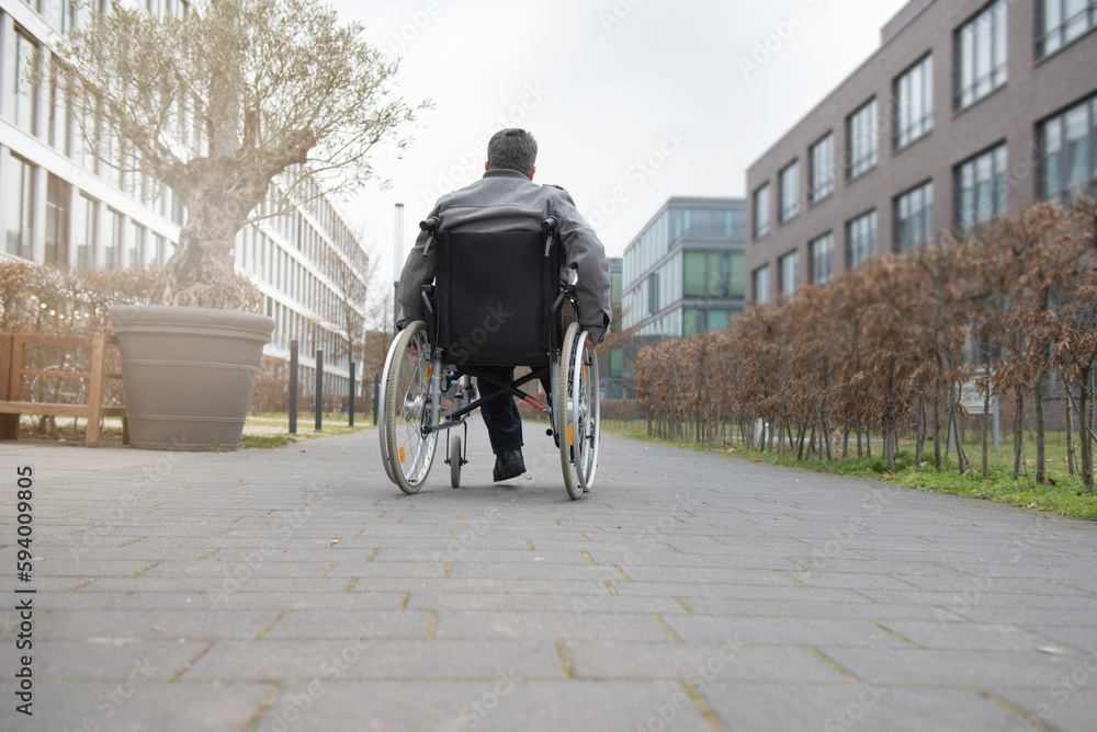 Obraz premium a physically disabled person on a wheelchair at a walk.