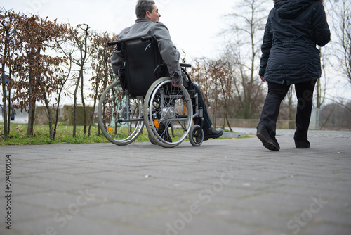 a physically disabled person on a wheelchair at a walk.