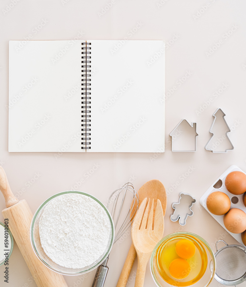 Simple home cooking - top view of blank cook book and wooden kitchen tool on white background. copy space Simple home cooking - top view of blank cook book and wooden kitchen tool on white background. copy space