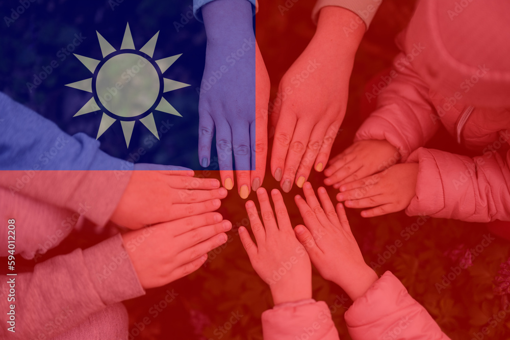Hands of kids on background of Taiwan flag. Taiwanese patriotism and unity concept.