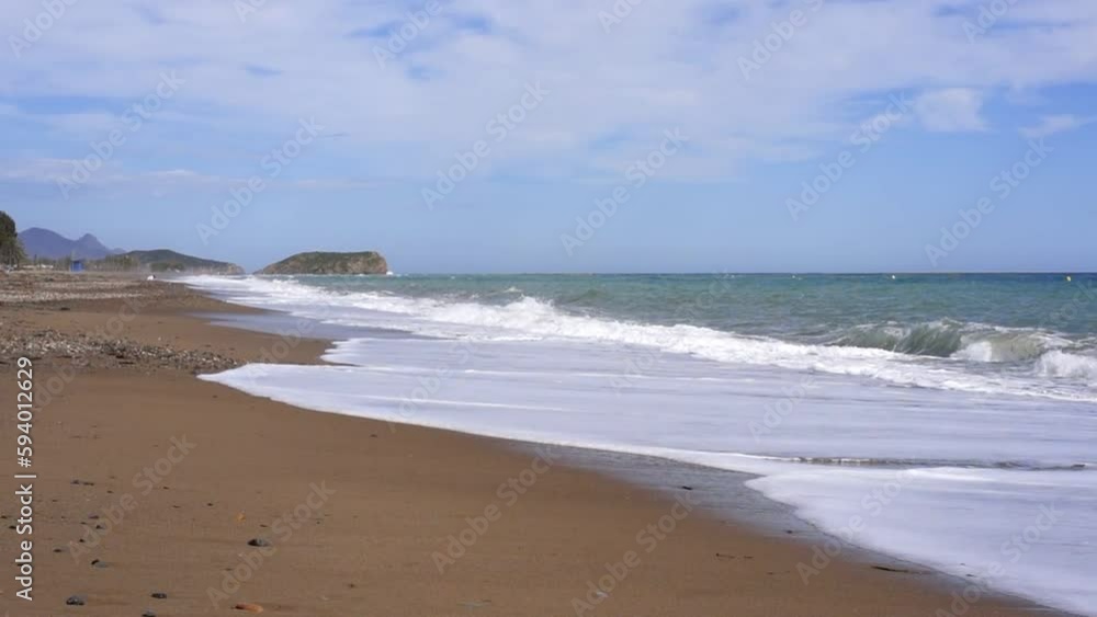 Beautiful view of foamy waves covering the coast in Costa Blanca, Spain Beautiful view of foamy waves covering the coast in Costa Blanca, Spain