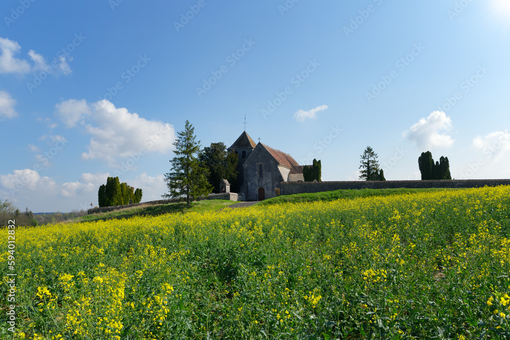 Rapeseed fields and old church in the French Gâtinais Regional Nature park Rapeseed fields and old church in the French Gâtinais Regional Nature park