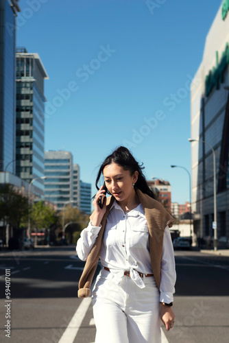 Businesswoman walking and talking on the street