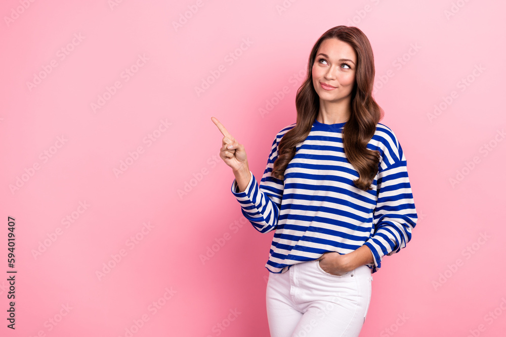 Portrait of good mood girl curly hairstyle striped clothes indicating look at proposition empty space isolated on pink color background Portrait of good mood girl curly hairstyle striped clothes indicating look at proposition empty space isolated on pink color background