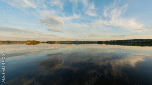 Summer lake scenery with clouds reflected on the water in Finland
