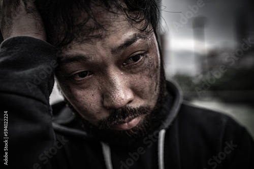 Asian man is homeless at the side road,A stranger has to live on the road alone because he has no family.