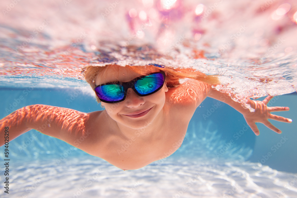 Kid swimming underwater. Summer kids. Happy little boy in swimming pool ...