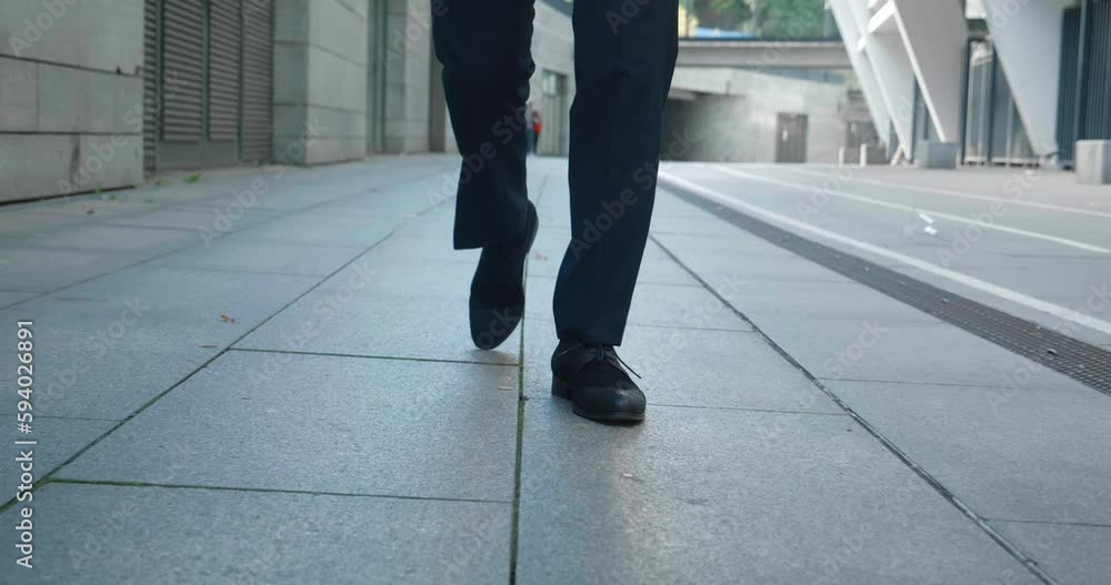 Front view feet of businessman commuting to work. Confident businessman in leather shoes and formal suit walking downtown near office building. Close up feet of business man walking at city outdoors Front view feet of businessman commuting to work. Confident businessman in leather shoes and formal suit walking downtown near office building. Close up feet of business man walking at city outdoors