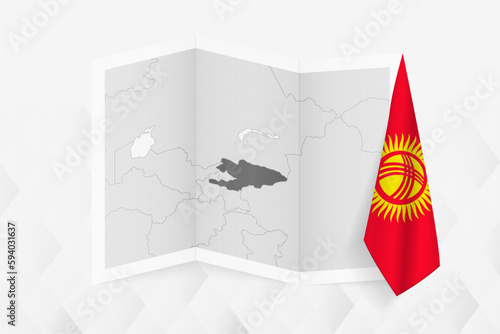 A grayscale map of Kyrgyzstan with a hanging Kyrgyzstani flag on one side. Vector map for many types of news. photo