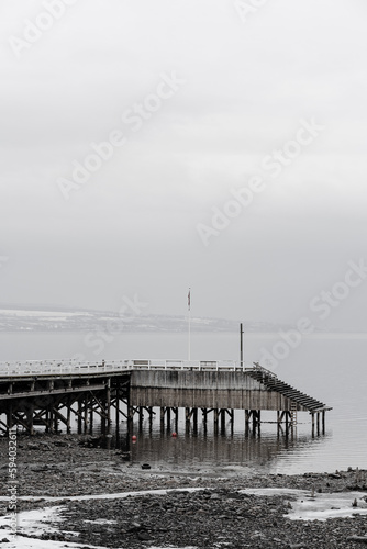 a wooden pier by Lake Mjøsa a rainy evening in spring photo