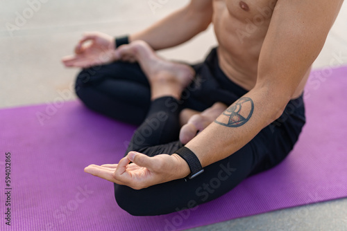 attractive hansome man with athletic strong body doing morning yoga dzen meditation