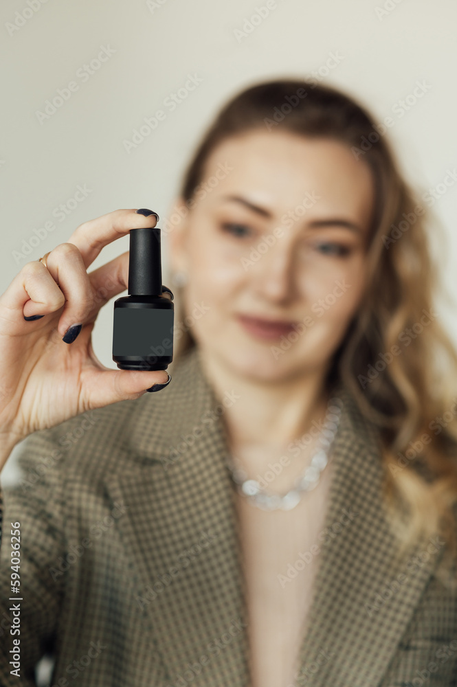 Woman nails master demonstrates new modern nail polish Woman nails master demonstrates new modern nail polish