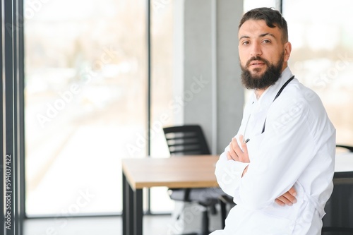 Portrait of a young arabian doctor standing in the the clinic