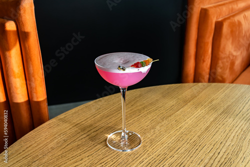 Shiny cocktail glass with fresh pink alcohol drink and jelly bears. Beverage and drinks backgrounds