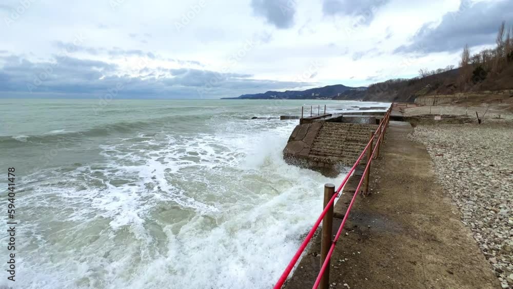 Powerful sea waves are crashing on the Black Sea coast. Waves run into the pier during a storm. Storm at sea. Panoramic view of the Black Sea. Russia. Sunset on the beach. 4K Powerful sea waves are crashing on the Black Sea coast. Waves run into the pier during a storm. Storm at sea. Panoramic view of the Black Sea. Russia. Sunset on the beach. 4K