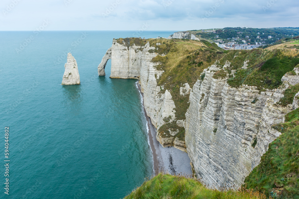 Scenic view of Etretat coast in Normandy France with calm sea against dramatic sky