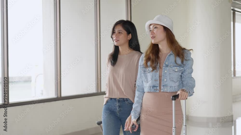 Two asian woman tourist friends checking flight information board for flight departure time, lifestyle and travel concept. Two asian woman tourist friends checking flight information board for flight departure time, lifestyle and travel concept.