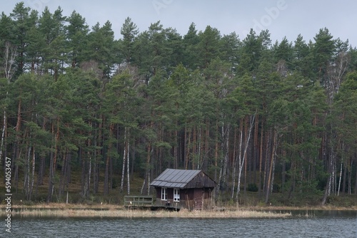 Little wooden house on island on lake Sztuczno, Kociewie, Poland photo