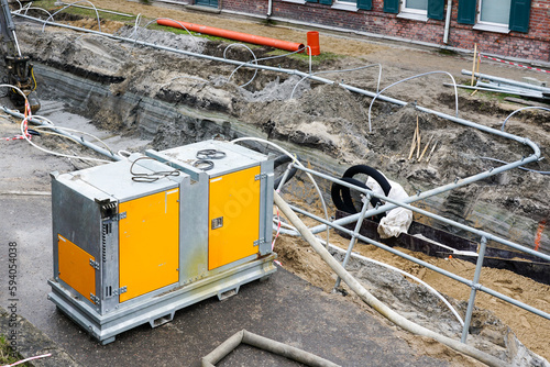 Large mobile diesel powered water pump for dewatering of deep underground piping replacement trench photo