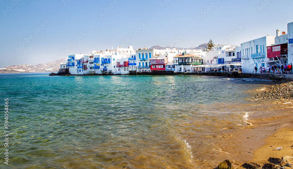 white houses of  Mykonos  next  to water.