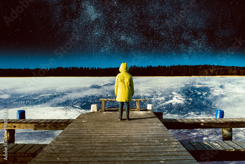 Surrealistic collage. A person stands on a bridge flying above the Earth, looks at the stars and space. (ID: 594055636)