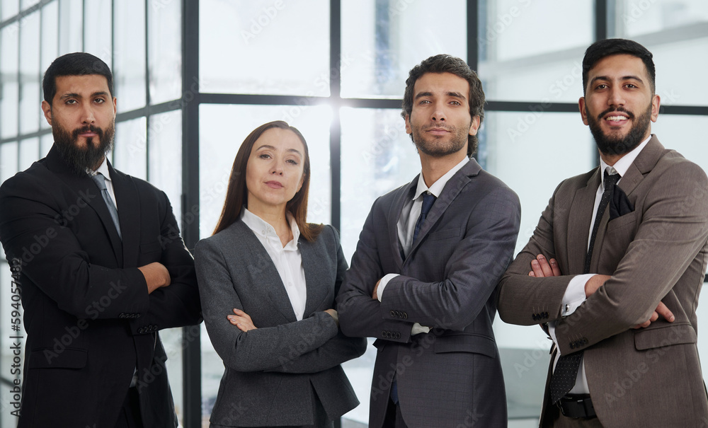 Portrait of four office workersr arms over their chest. Portrait of four office workersr arms over their chest.
