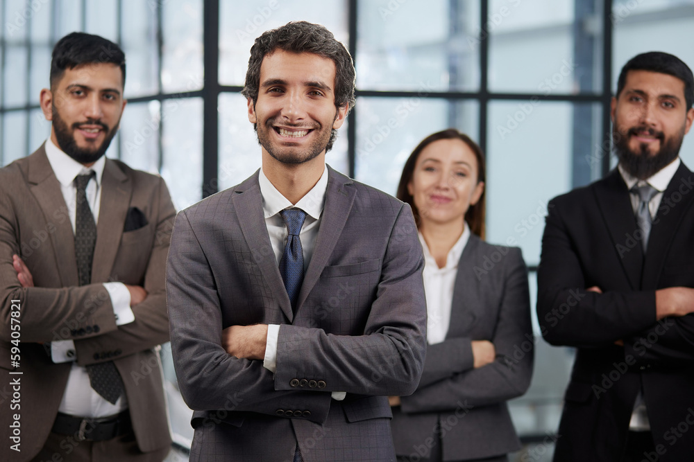 Group portrait of four successful young business people. Team of 4 happy confident businesspeople in smart office wear Group portrait of four successful young business people. Team of 4 happy confident businesspeople in smart office wear
