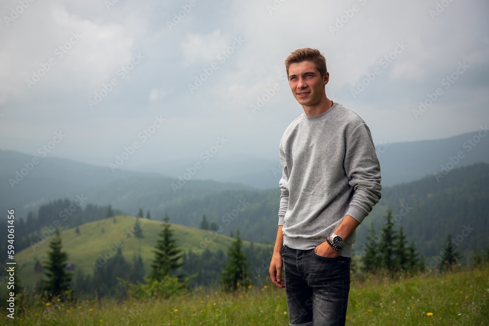 Caucasian white man on the background of green hills Caucasian white man on the background of green hills