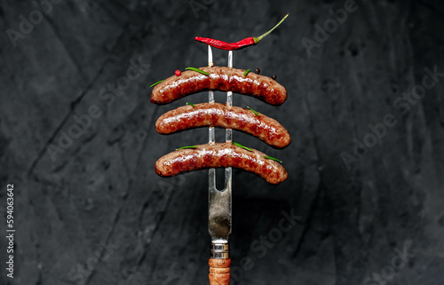 grilled beef sausages on a meat vidka on a stone background photo