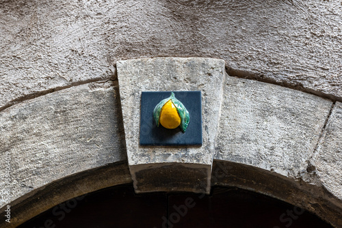 Lemon decoration above the arch on one of the streets in Limone sul Garda, Italy