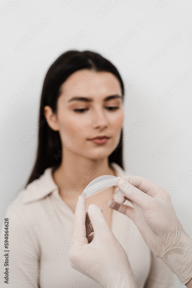 Nasal splints airways are two pieces of plastic held inside nose. ENT doctor is showing nasal splints to patient before septoplasty surgery. Nasal splints airways are two pieces of plastic held inside nose. ENT doctor is showing nasal splints to patient before septoplasty surgery.