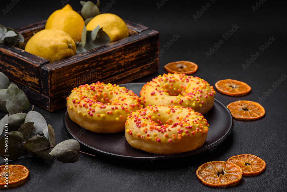 Delicious fresh donuts in yellow glaze with lemon flavor filling