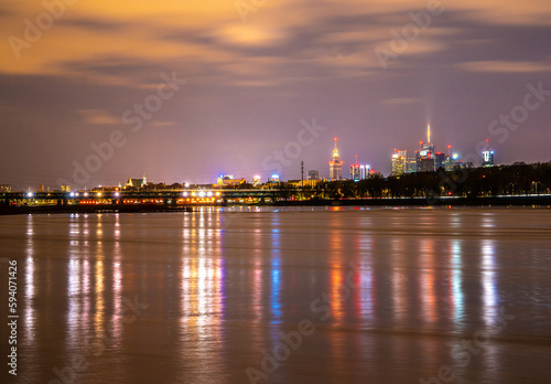 night panorama of warsaw reflected in the wisła river