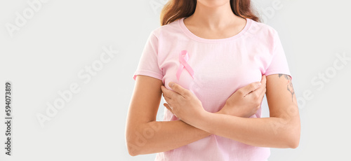 Young woman with pink ribbo...