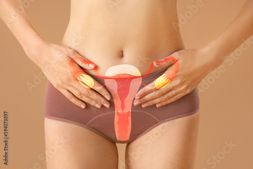 Young woman in menstrual panties on beige background, closeup photo