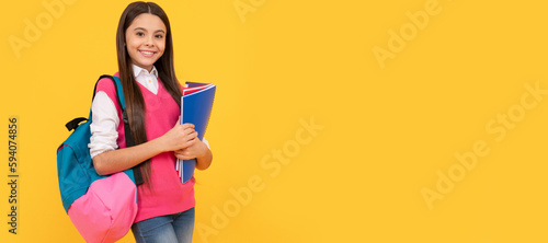 happy teen school girl with backpack and copybook on yellow background, school. Banner of schoolgirl student. School child pupil portrait with copy space.
