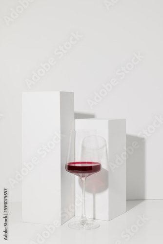 Red wine in glass on white background with shadow © Bojanikus
