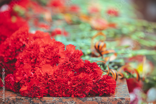 Close-up, the flower lying on the monument in memory of Soviet soldiers who died in the Great Patriotic War of 1941-1945. May 9, Victory Day. Selective focus photo