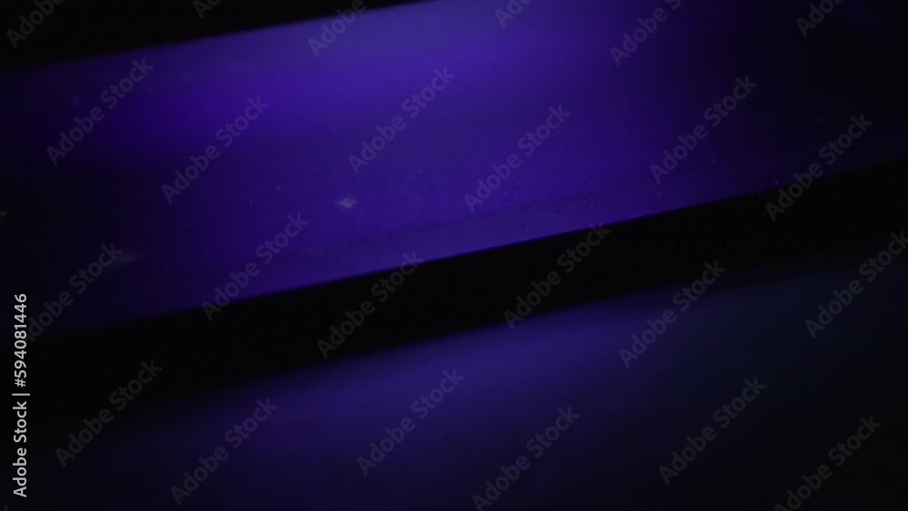 Soft focus on dollar banknote under ultraviolet light. Portrait of Benjamin Franklin is inspected. Background to concept of counterfeiting money. Checking dollars under UV lamp. bundle of money Soft focus on dollar banknote under ultraviolet light. Portrait of Benjamin Franklin is inspected. Background to concept of counterfeiting money. Checking dollars under UV lamp. bundle of money