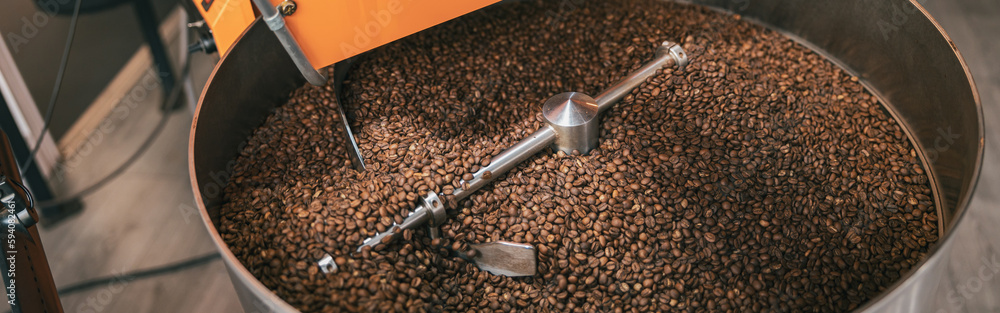 Close up of coffee roasting machine with coffee beans in small coffee manufacturing Close up of coffee roasting machine with coffee beans in small coffee manufacturing