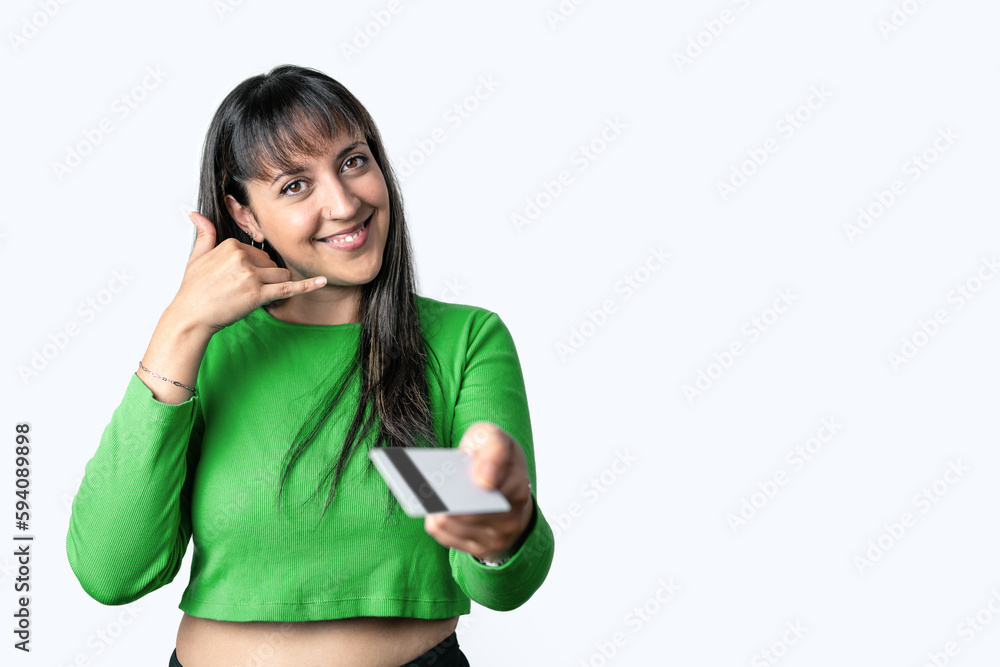 Woman holding a credit card and making phone call gesture on white background Woman holding a credit card and making phone call gesture on white background