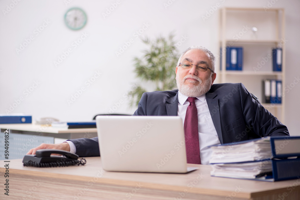 Old male employee and too much work in the office Old male employee and too much work in the office