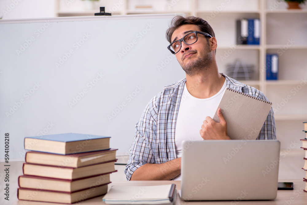 Young male student preparing for exams in the classroom Young male student preparing for exams in the classroom