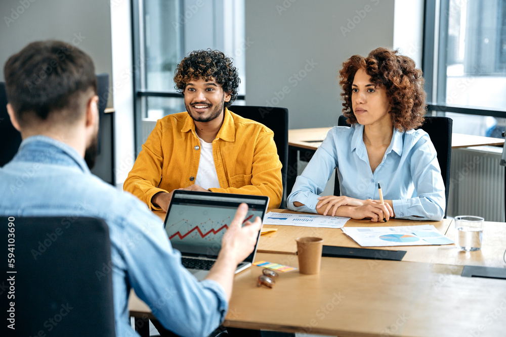 Successful positive multiracial business people, working together in the office, have brainstorm in a meeting room, discuss financial and promotion strategy of a project, smile to each other Successful positive multiracial business people, working together in the office, have brainstorm in a meeting room, discuss financial and promotion strategy of a project, smile to each other