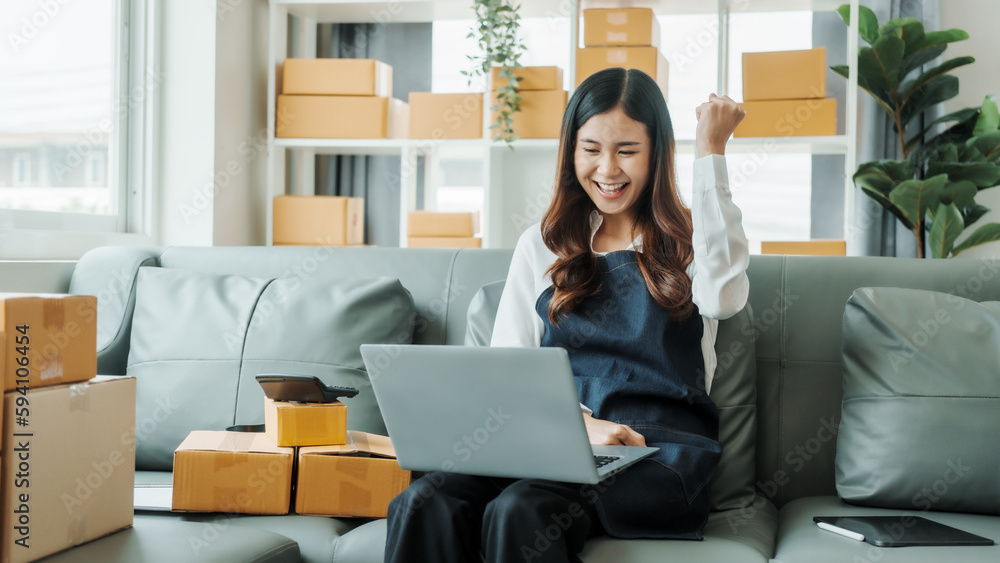 so glad, happy, Young pretty Asian female influencer small businesses SME owners female entrepreneurs working on receipt box and check online orders, sitting on sofa of home online business. so glad, happy, Young pretty Asian female influencer small businesses SME owners female entrepreneurs working on receipt box and check online orders, sitting on sofa of home online business.