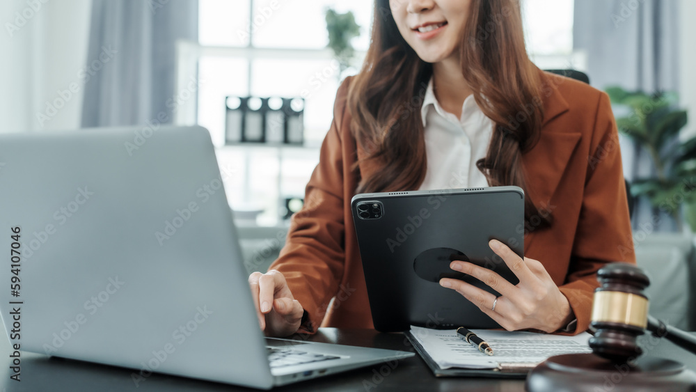 Using tablet pc, Online consulting with laptop in office of asian thai japanese chinese female exclusive lawyer legal advisor, legislation, saleswoman, legal contract documents Using tablet pc, Online consulting with laptop in office of asian thai japanese chinese female exclusive lawyer legal advisor, legislation, saleswoman, legal contract documents