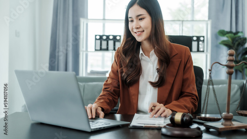 Online consulting with laptop in office of asian thai japanese chinese female exclusive lawyer legal advisor, legislation, saleswoman, legal contract documents