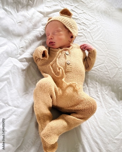 Newborn baby dressed up as a teddy bear 