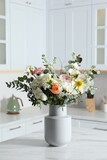 Bouquet of beautiful flowers on white table indoors